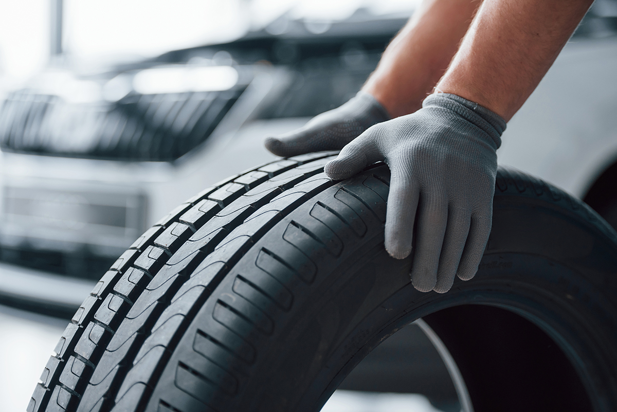 hands-only-mechanic-holding-tire-repair-